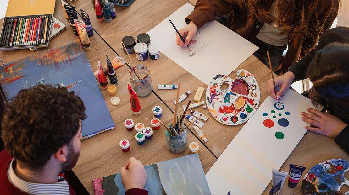 Students engage in a group art project. 